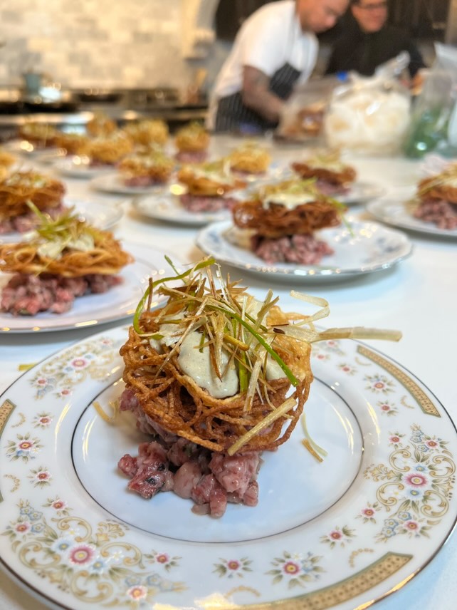 Elegant tartare appetizers on decorative china plates for private party catering
